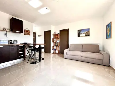 a living room with a couch and a table at Appartement 2 chambres à Lama avec Piscine in Lama