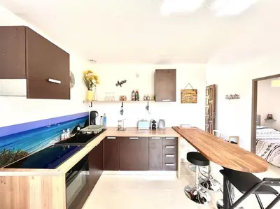 a kitchen with a sink and a wooden counter top at Appartement 2 chambres à Lama avec Piscine in Lama
