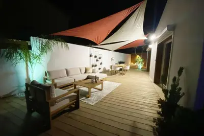 a living room with a couch and a table at Mini Villa Indépendante à 350m de la mer (LAX) in Lucciana