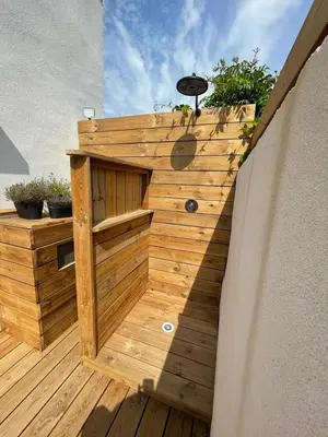 a wooden deck with a wooden stairway with a wooden wall at Mini Villa Indépendante à 350m de la mer (LAX) in Lucciana