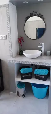 a bathroom with a sink and a mirror at Appartement Chiola-Plage à pieds-clim in Solaro