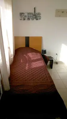 a bedroom with a large bed with a red bedspread at VILLA T3 bord de mer - vue mer à 500 m de la plage- piscine chauffée A CASETTA DI A SPIAGGIA in Cervione