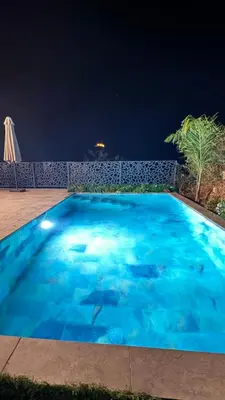 a swimming pool at night with sharks in it at A CASA DI LAURENA piscine chauffée proche St Florent in Vallecalle