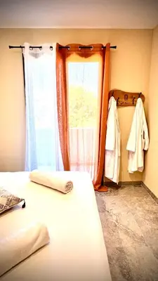 a room with two beds and a window and a window at A CASA DI LAURENA piscine chauffée proche St Florent in Vallecalle