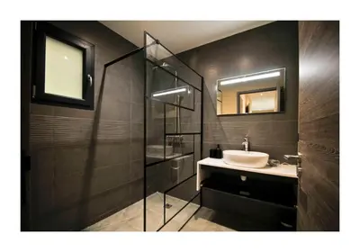 a bathroom with a sink and a glass shower at A CASA DI LAURENA piscine chauffée proche St Florent in Vallecalle