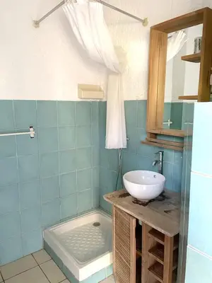 a bathroom with a sink and a mirror at Charmant studio à Linguizzetta 23 m² avec terrasse privéeC in Linguizzetta