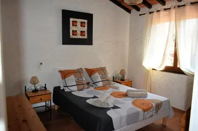 a bedroom with a bed with hats on it at Maison de plage pour 10 personnes de 4 chambres front de mer Corse-du-Sud in Appietto