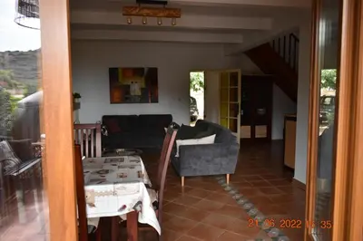a living room with a couch and a table at Maison de plage pour 10 personnes de 4 chambres front de mer Corse-du-Sud in Appietto