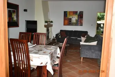 a living room with a couch and a table and chairs at Maison de plage pour 10 personnes de 4 chambres front de mer Corse-du-Sud in Appietto