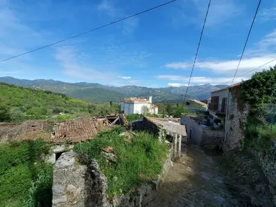 a view of a village with mountains in the background at Studio 2A in Ucciani