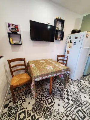 a kitchen with a table and a refrigerator at Studio 2A in Ucciani