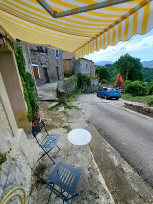 a table and chairs on the side of a street at Studio 2A in Ucciani
