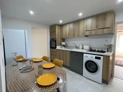 a kitchen with a table and a washing machine at A COLETTA in Piana
