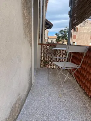 a chair sitting on the balcony of a building at A COLETTA in Piana