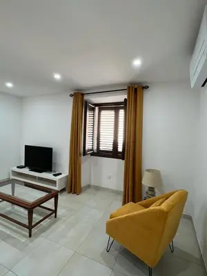 a living room with a couch and a tv at A COLETTA in Piana