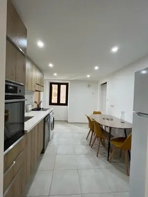a large kitchen with a table and a dining room at A COLETTA in Piana