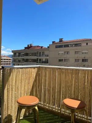 two chairs on a balcony with buildings in the background at Super Studio centre ville d'Ajaccio in Ajaccio