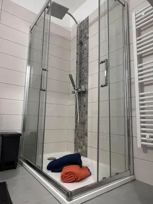 a bathroom with a shower with a towel on a tub at Super Studio centre ville d'Ajaccio in Ajaccio