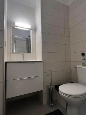 a bathroom with a toilet and a sink and a mirror at Super Studio centre ville d'Ajaccio in Ajaccio