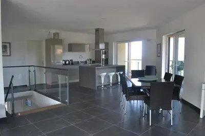 a kitchen and dining room with a table and chairs at Villa Maremuntagna Porto Vecchio in Porto-Vecchio