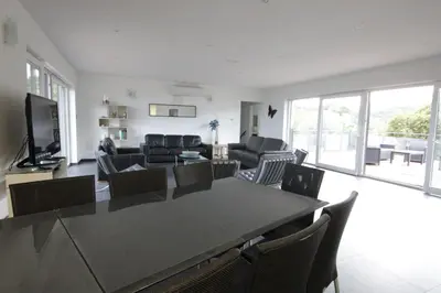 a living room with a table and chairs at Villa Maremuntagna Porto Vecchio in Porto-Vecchio