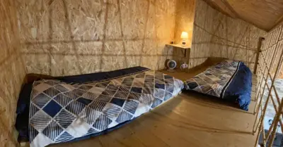 a bedroom with two beds in a room at Gîte chez Arthur in Vezzani