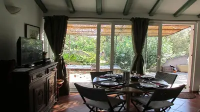 a dining room with a table and chairs and a window at MiniVilla 