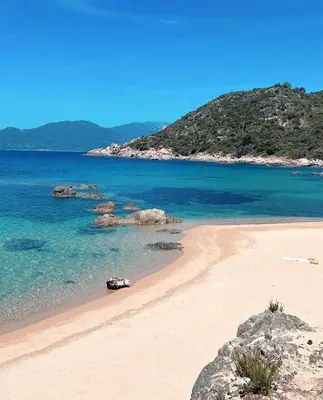 a beach with rocks and the ocean and blue water at La vallée in Belvédère