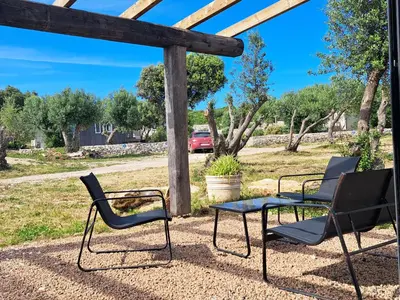 three chairs and a table on a patio at Maison au calme idéalement située proche plage in Bonifacio